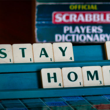 stay at home written out on a game board